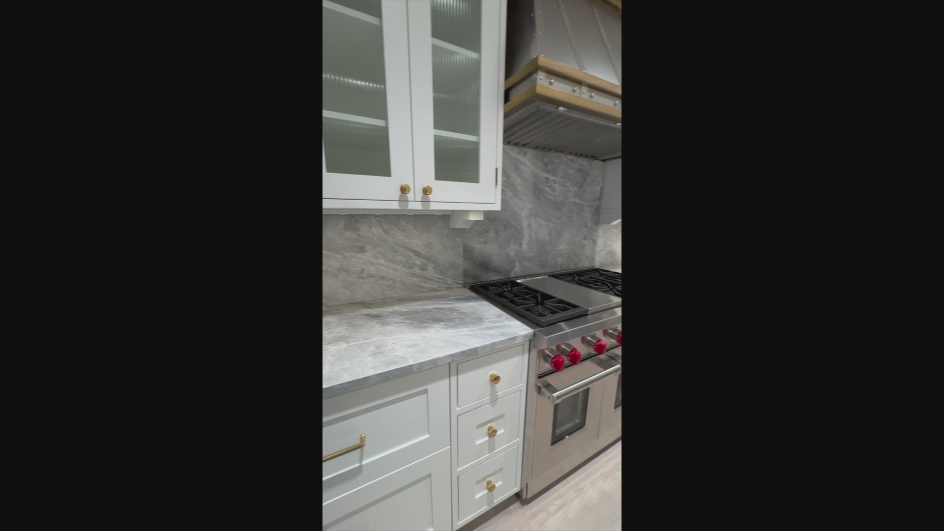 Load video: Close up view of the Sub-Zero 648PROG 48 inch stainless steel professional refrigerator in an open luxury kitchen layout