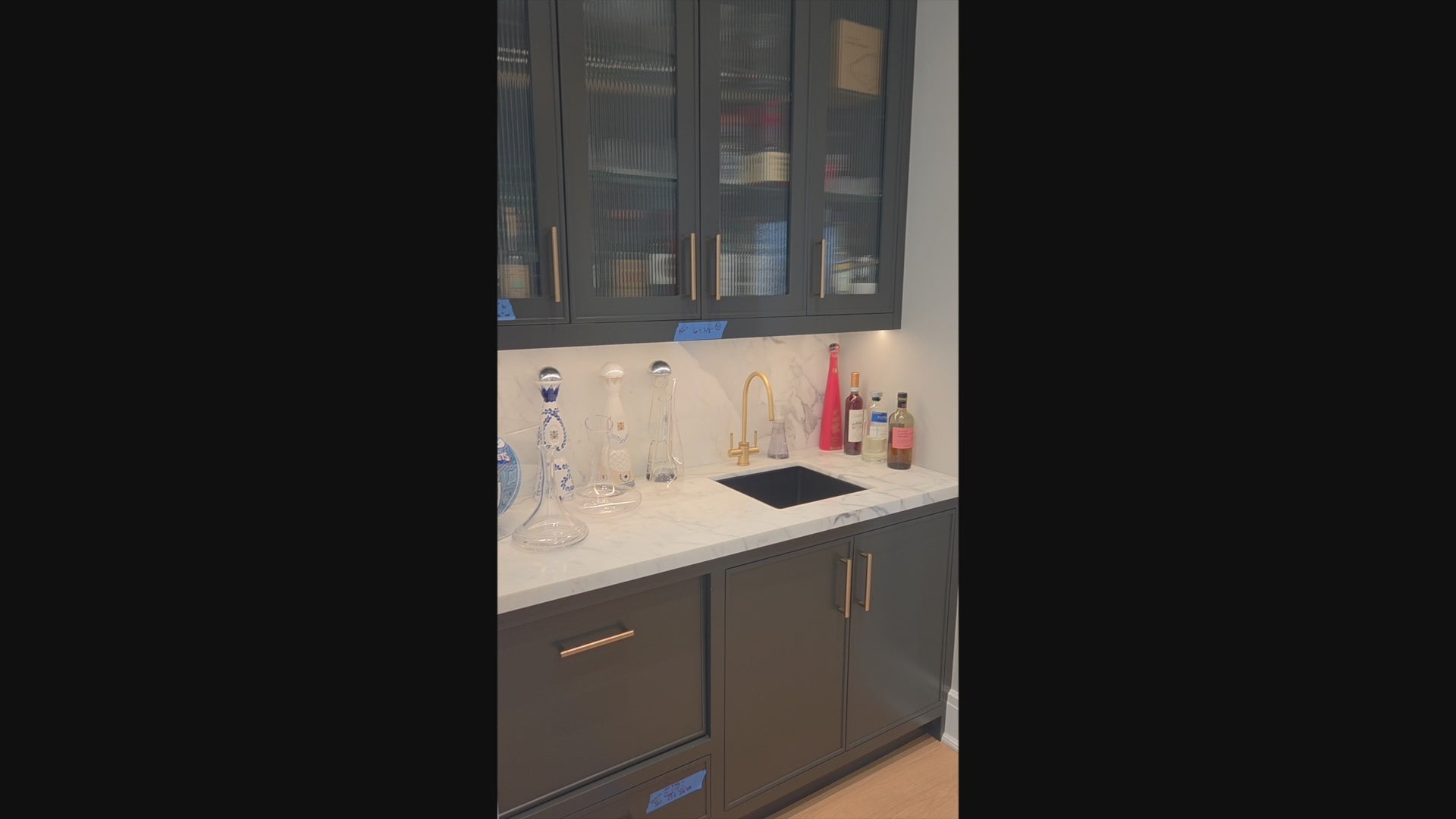 Load video: Custom Transitional Black Wet Bar with White Marble Countertops