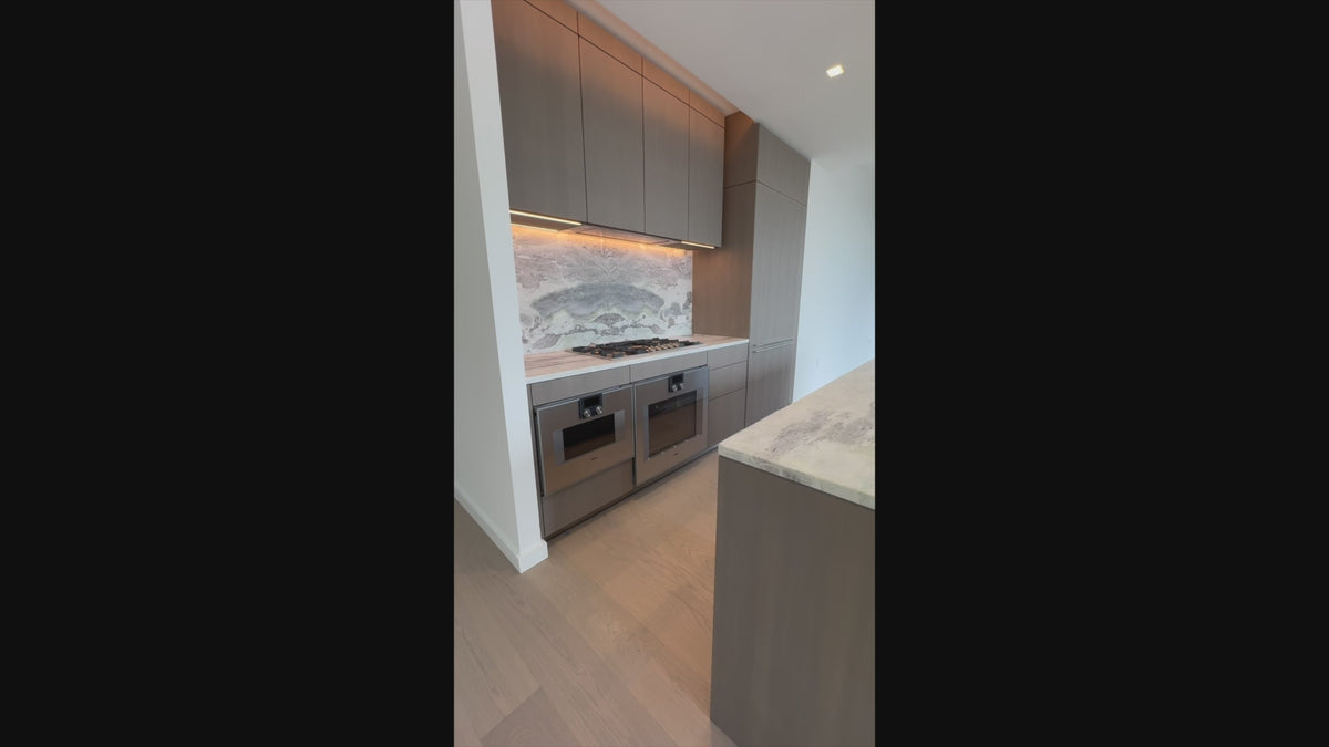 Load video: The Tribeca modern kitchen with central island and Gaggenau appliances