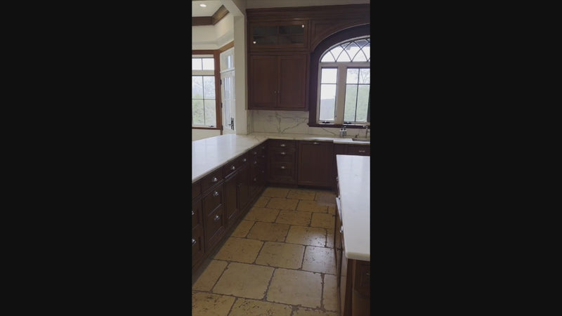 Luxury estate kitchen with rich wood cabinetry and ornate stone countertops