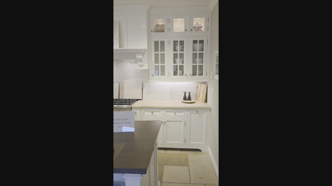 Load video: Signature Custom Cabinetry Transitional White Kitchen with Wood Veneer Top Island and Stone Countertops