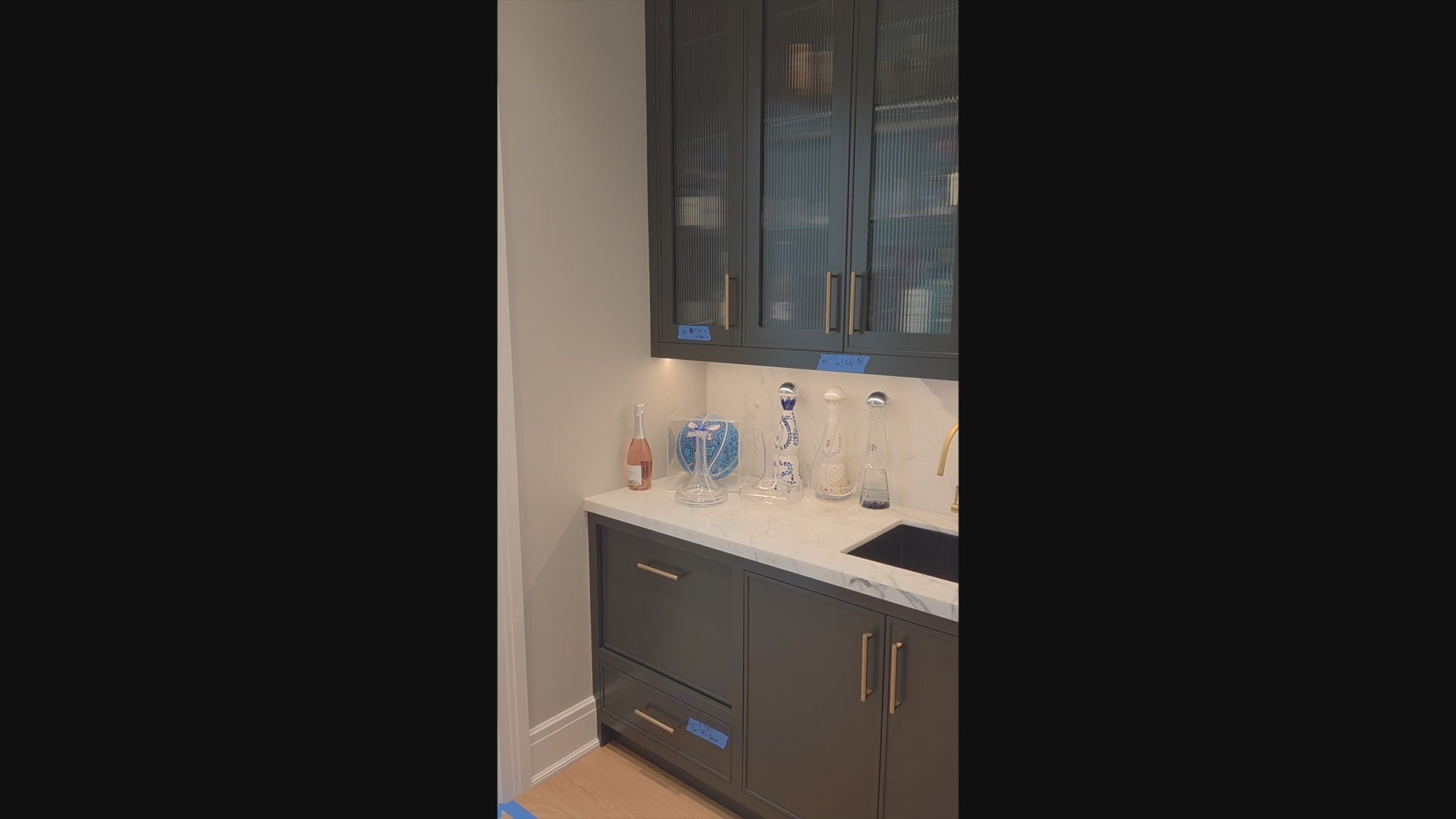 Load video: Custom Transitional Black Wet Bar with White Marble Countertops