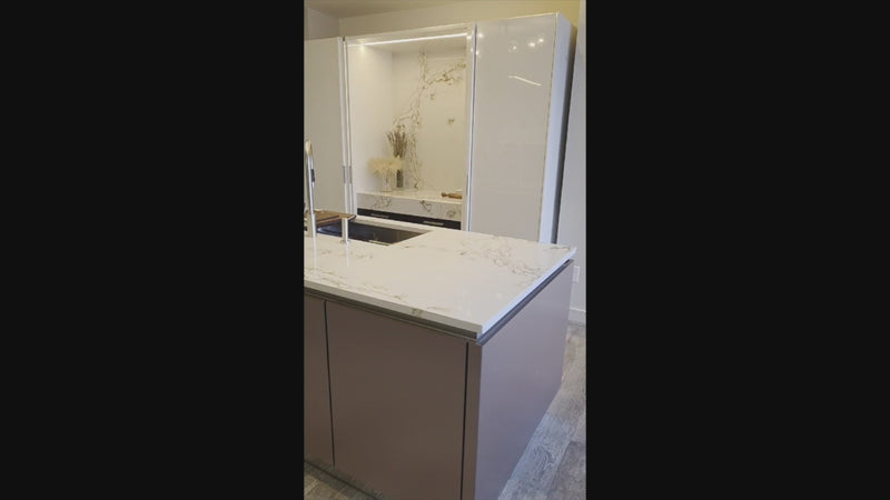 SieMatic Modern Rose Gold Handleless Island with Lotus White Hideaway Pantry with Pocket Doors